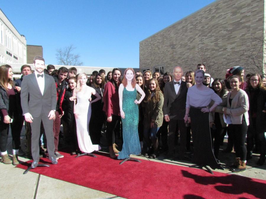 Students pose with card board cut outs of Oscar nominees.