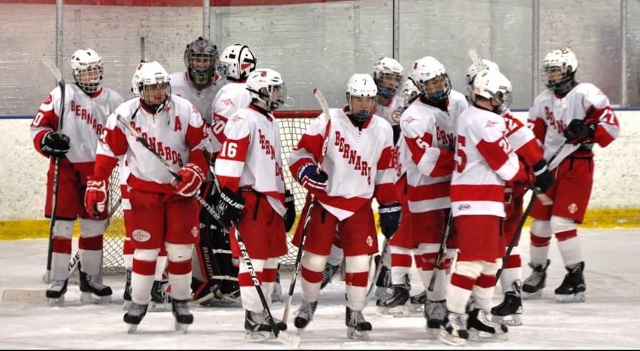 Hockey players get together to wish each other good luck before the game. 