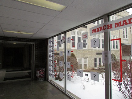 The March Madness bracket in the glass hallway.