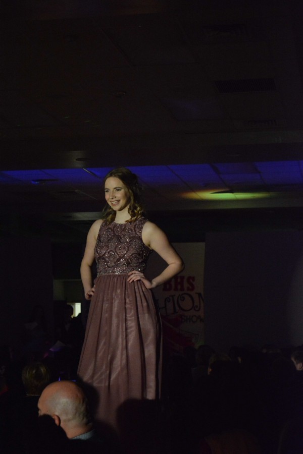 Maggie Fischer poses for a picture at the end of the runway