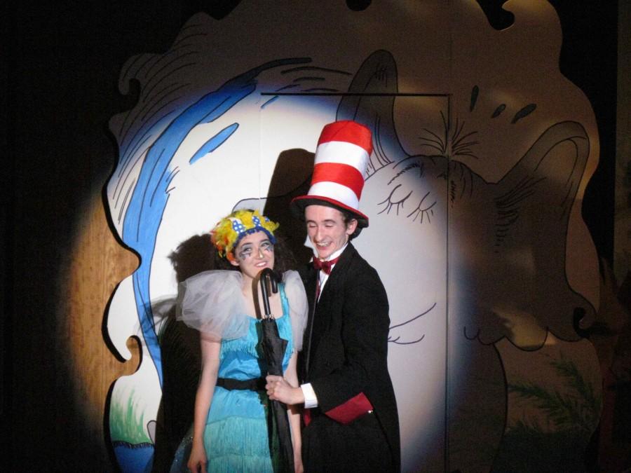 Julie de Diego and Connor McShane singing into the umbrella.