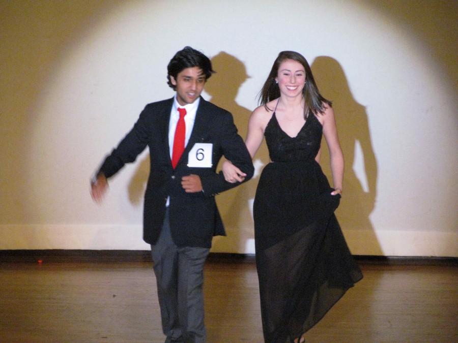 Jett Sing and Mia Ciardi walk the runway with smiles on their faces.