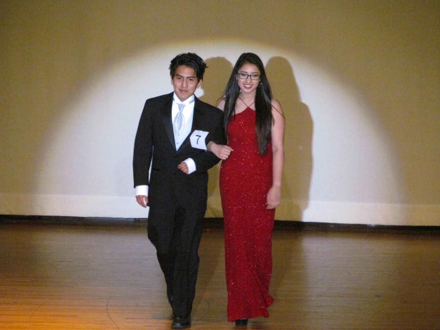 Leo Rivera and Kim Walker link arms to walk the runway.