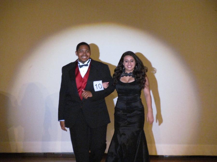 Darian and his date smiling as they walk down the stage.