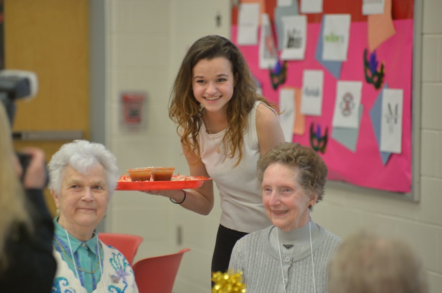 Senior Lauren Eddy smiling with her two new friends. 