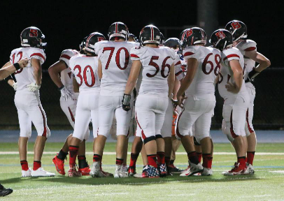 The offense huddles up during a game against Johnson