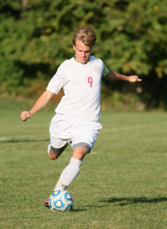 Senior Dan Schindler kicks the ball