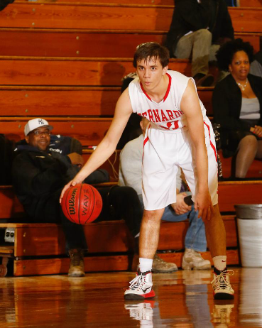 Senior Zach Walljasper dribbling down the court