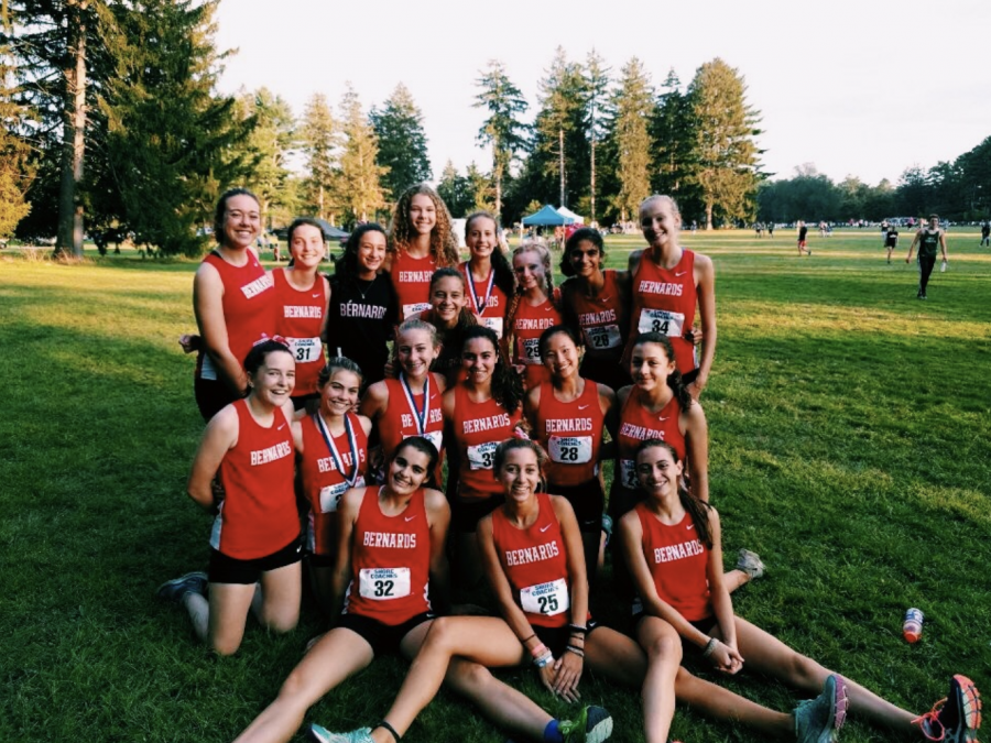 Girls cross country team celebrates after a successful meet