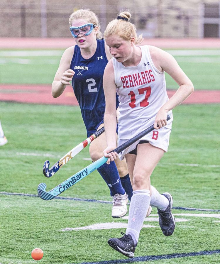 Senior Grace Connell running up the field with the ball