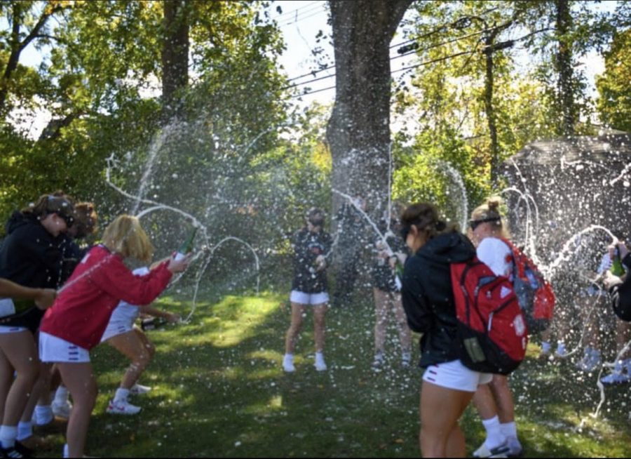 Girls soccer celebrating their Division Championship victory after the game at the High School