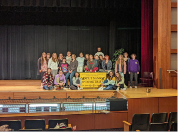 Cast of 25th annual putnam spelling bee together on stage on their debut night 