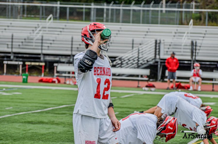 Senior Zach Cohen drinking water during warmups in a game against MKA. Permission given by Ar5Media. 