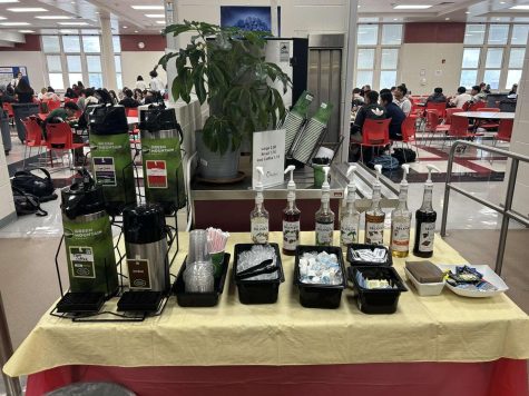 Coffee bar located in the cafeteria on its first-day release. Consisting of various coffee flavors, iced, sweetener choices, and cups. 