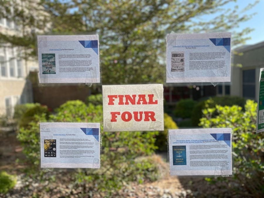 Final four books displayed in the glass hallway; students voted each week over the duration of March, narrowing it down from 32 to 4 books