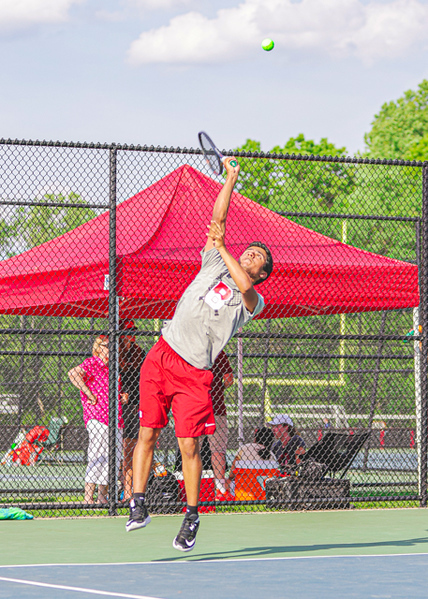 Sophomore Neal Chaayanath serving the ball. Normandy Studio gave us permission to use this photo.