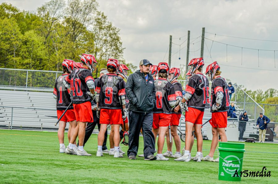 The Boys Lacrosse team in the pre-game huddle before their game at Randolph. Ar5media gave BHS Crimson permission to use photo.