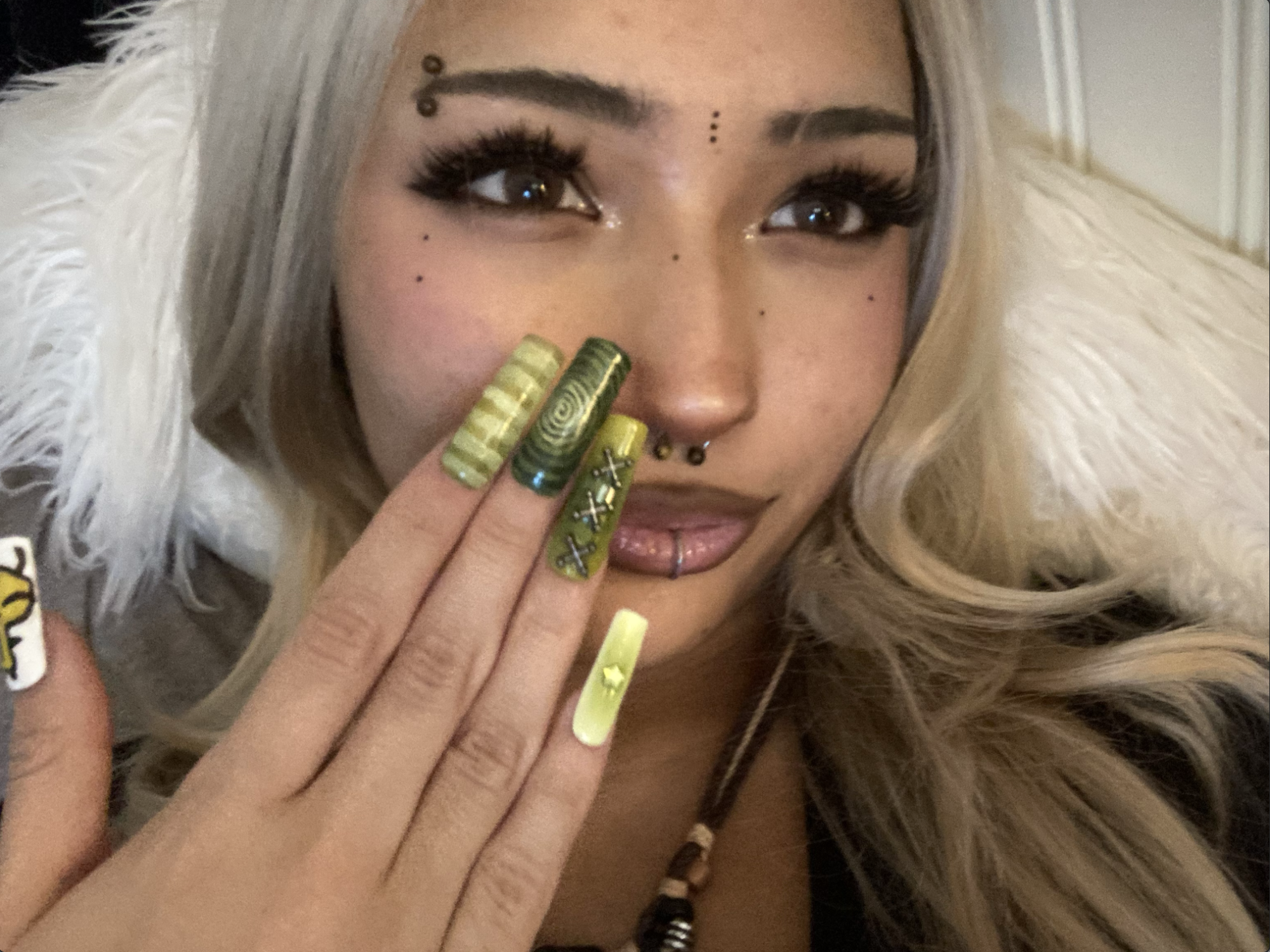 Kylie Rivera poses with one of her handmade nail sets