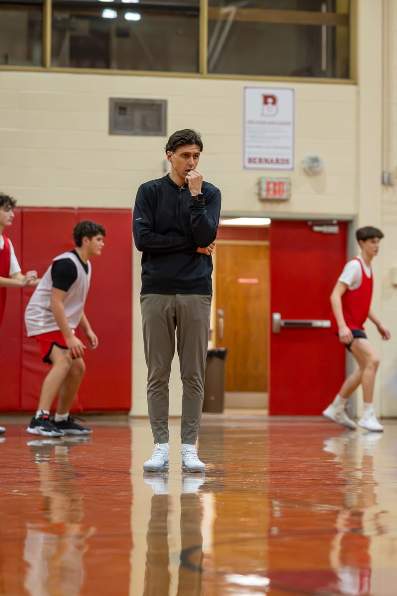 Coach Johnson waiting around to make a call during a basketball practice 