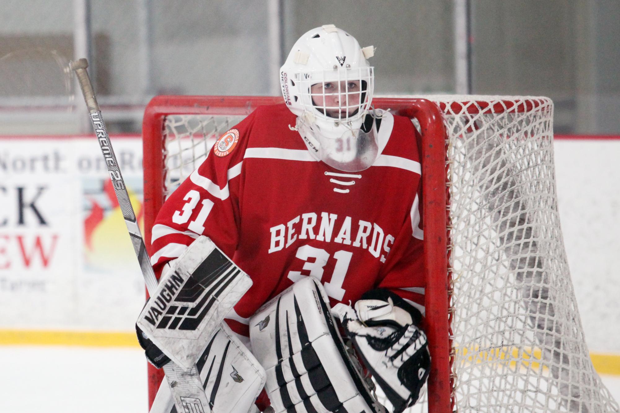 As hockey goalie, Baylyn stands in front of the goal on the rink