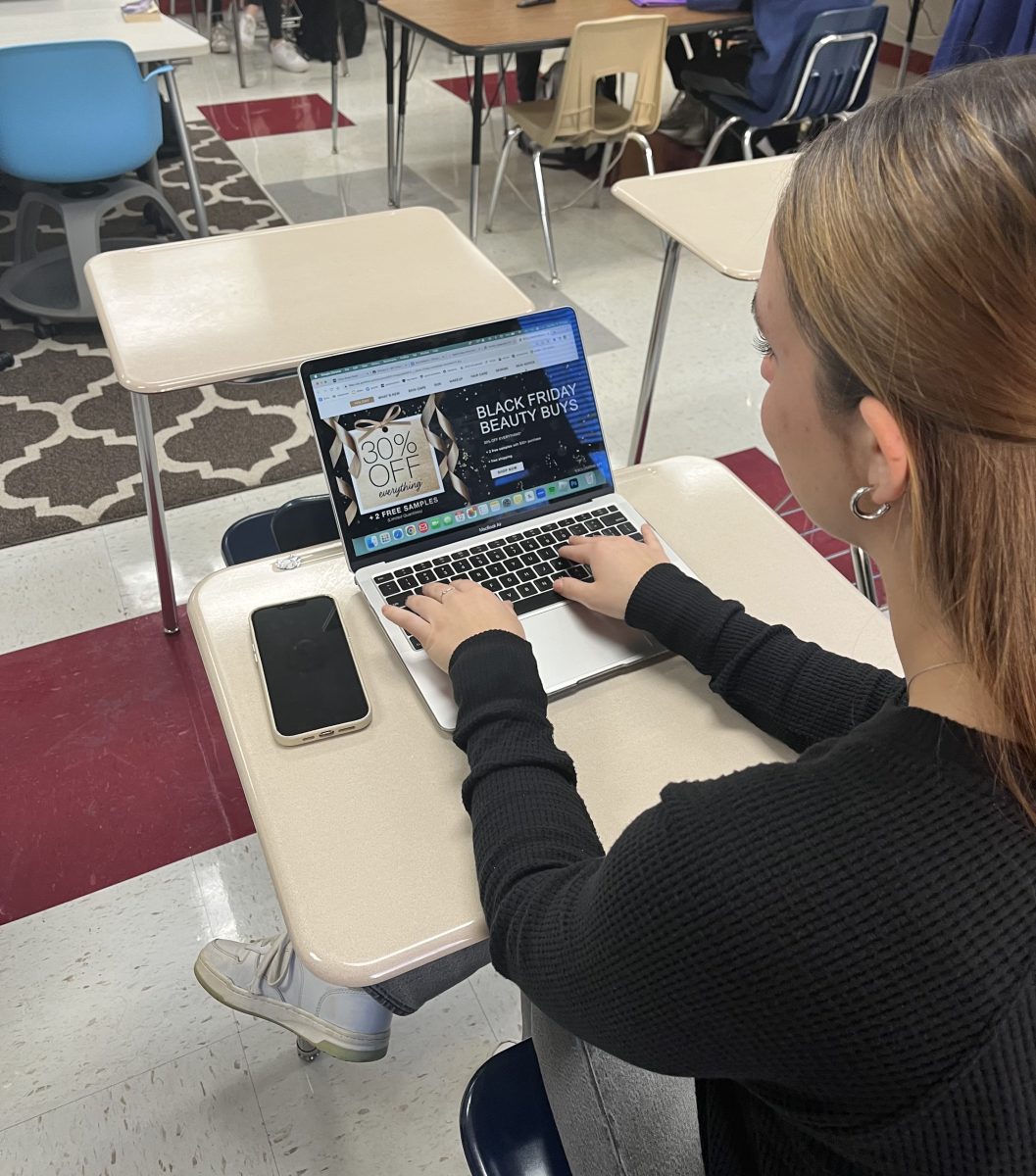 A student is shopping for Black Friday deals online instead of in person