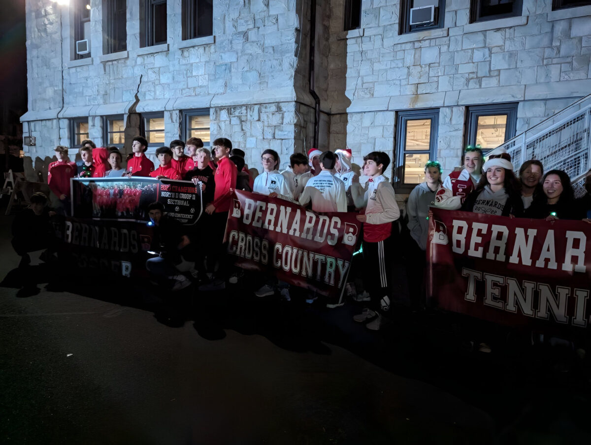 The+Bernards+High+School+cross+country+boys+holding+their+banner+for+the+parade.