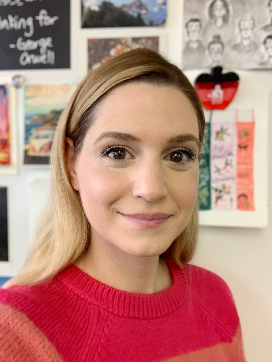 English teacher Ms. Volosin smiles for a photo in her classroom