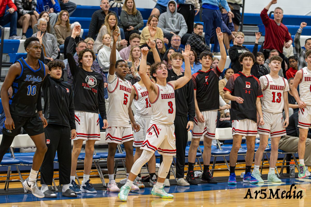 The bench mob celebrating a 3 pointer during a game against Gill