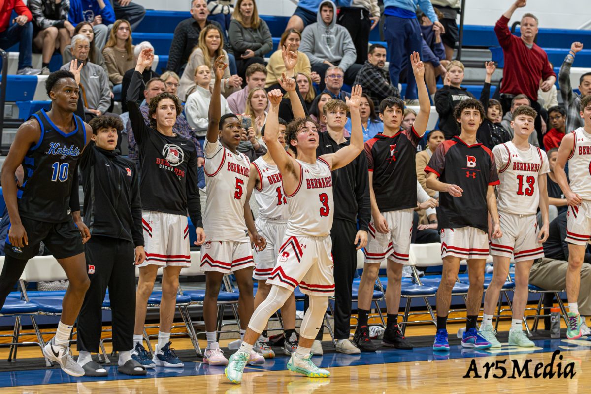 The+bench+mob+celebrating+a+3+pointer+during+a+game+against+Gill