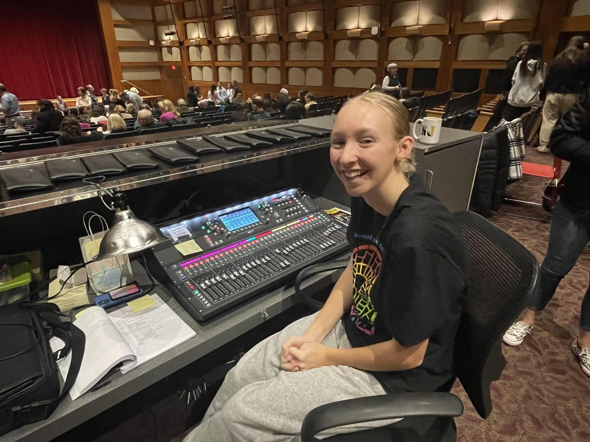 Addison Dunn sits behind and operates the soundboard for the musical