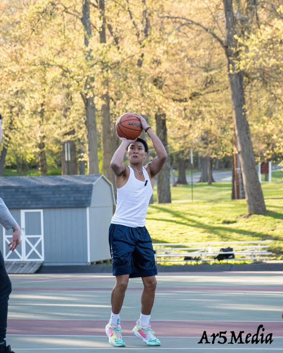 Senior+Gabe+Morales+takes+a+three-pointer+in+the+intramural+matchup.