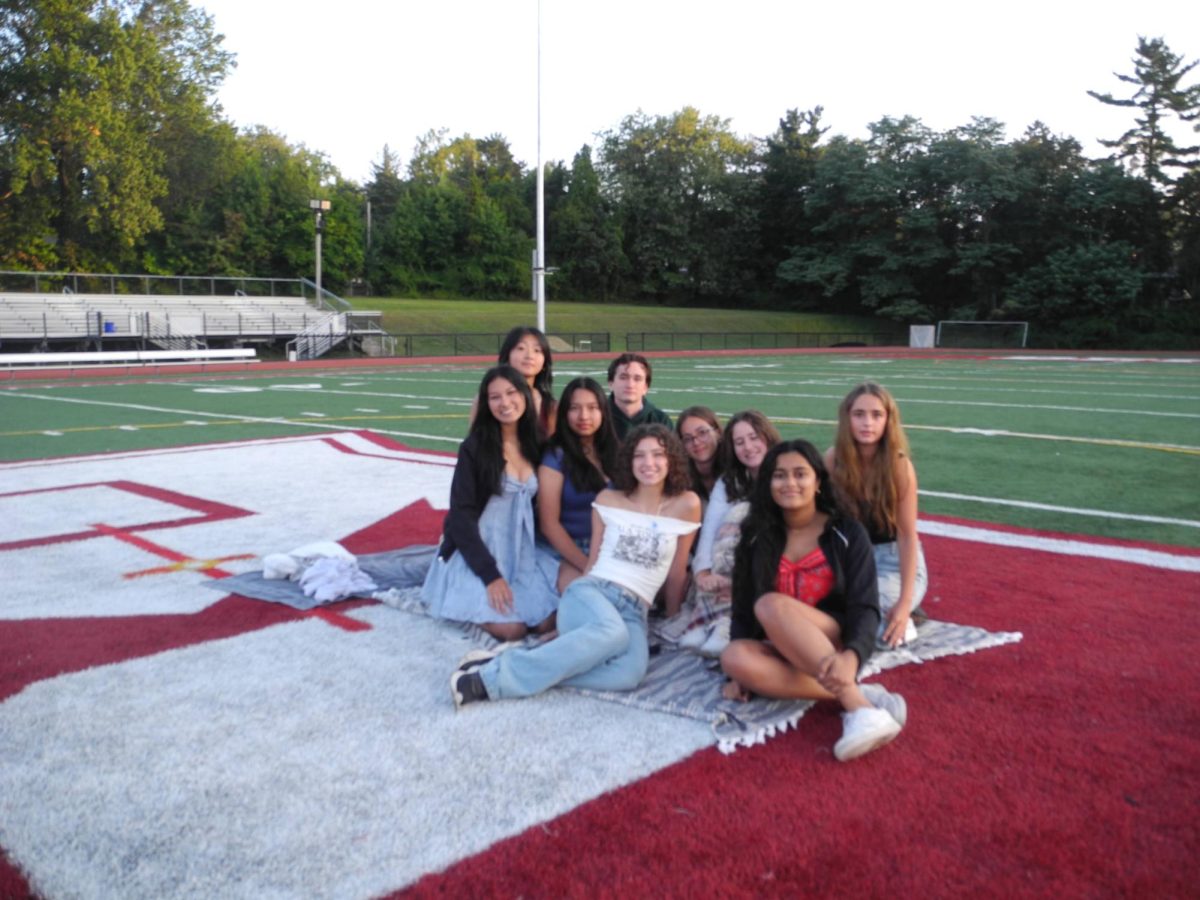 This Seniors group comes together on the turf to watch the sunrise. 