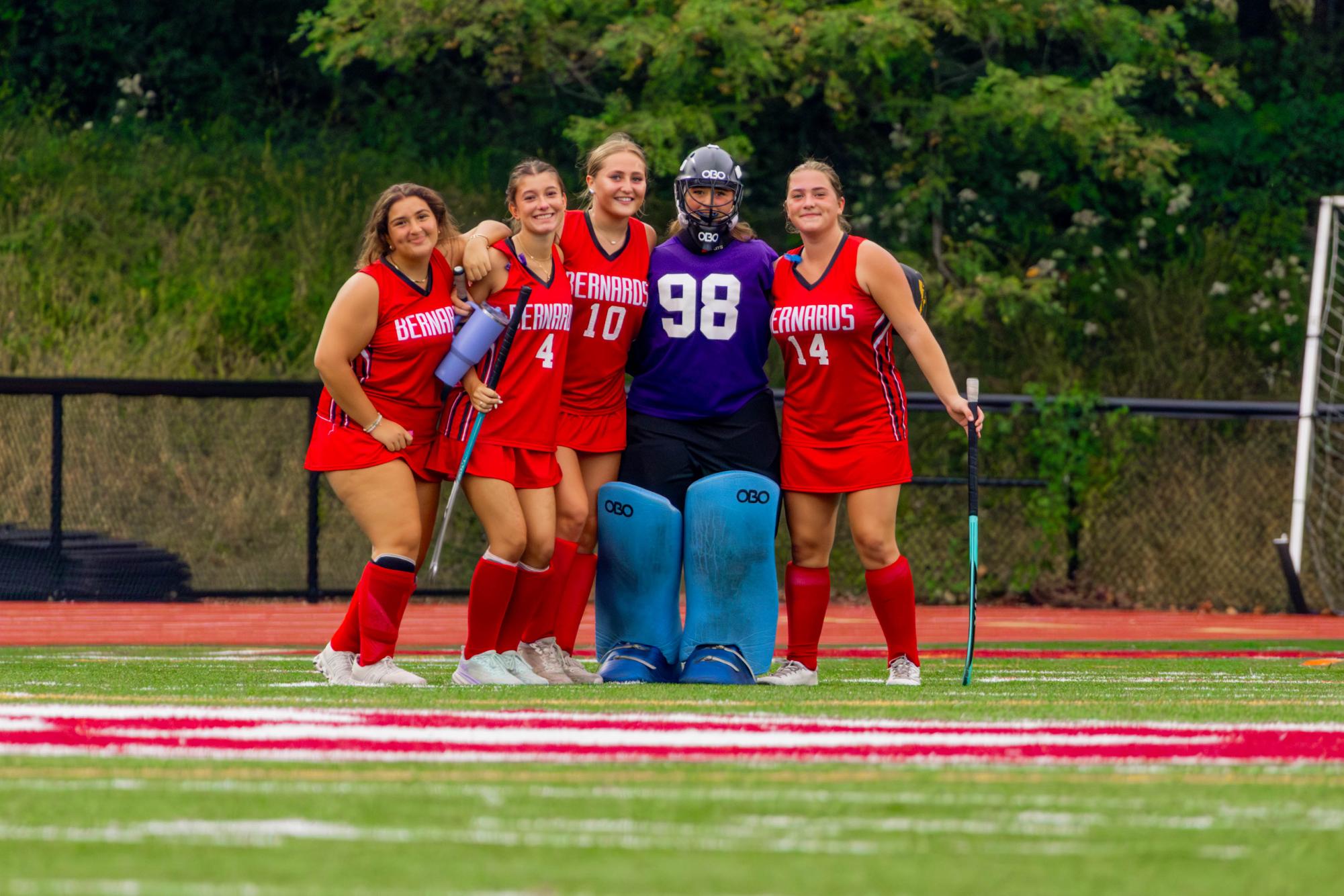 Girls Field Hockey Varsity players pose for a picture