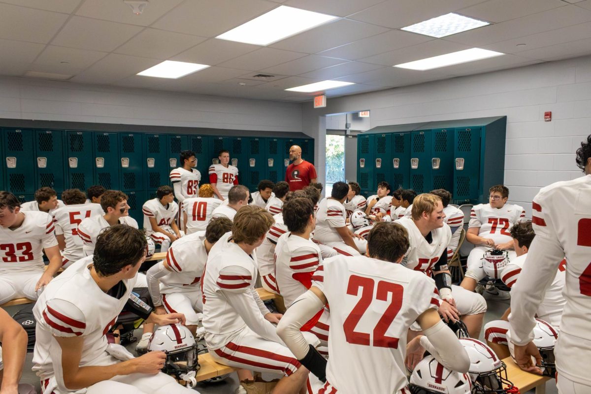 Head Coach Simoneau goes over the gameplan before their week 6 win over South Plainfield. Photo used with permission of dunnder_media