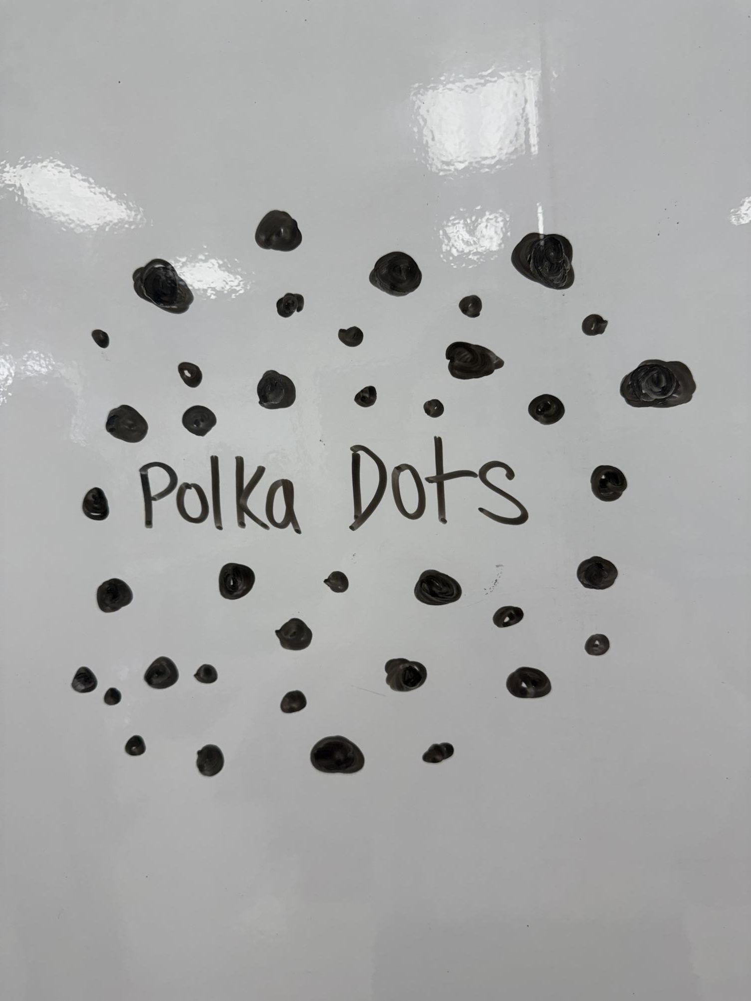 Picture of polka dots drawn out on a whiteboard.