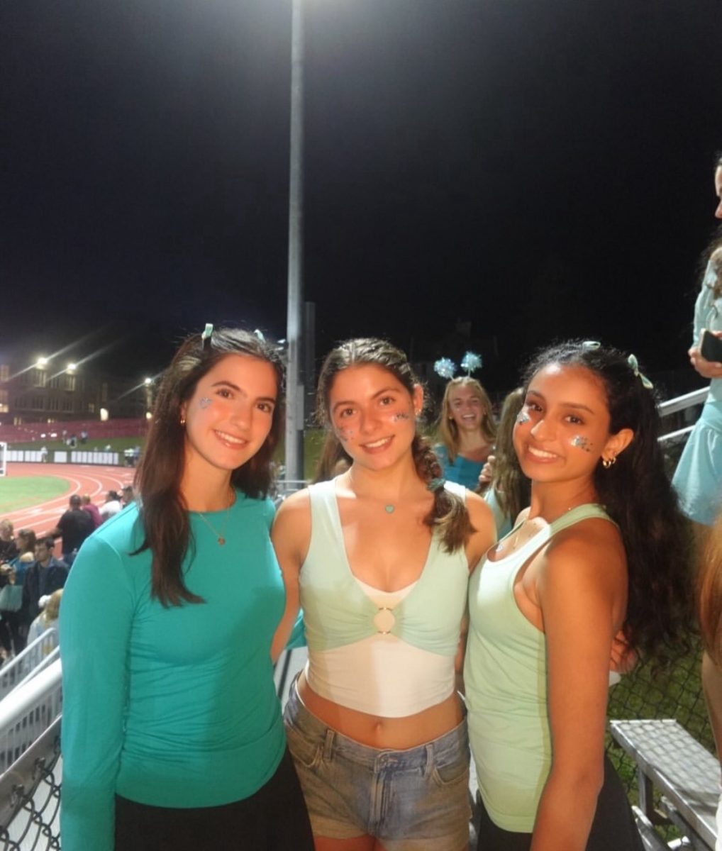 Anakh Sawhney (Right) poses for a photo with her friends at Bernards football game.