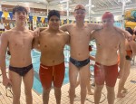 The boys swim team poses for a picture