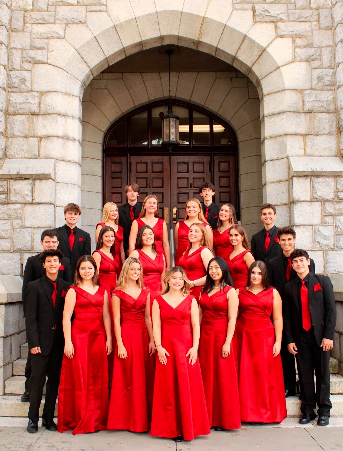 The 25-26 madrigals pose outside of the Olcott Building for a photo
