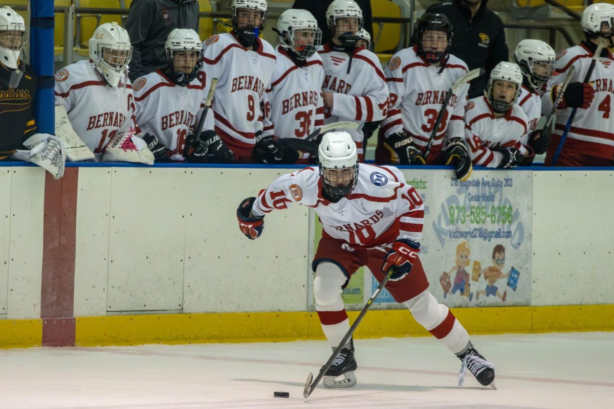 The bench watches on as the BSM Hockey team takes on Madison