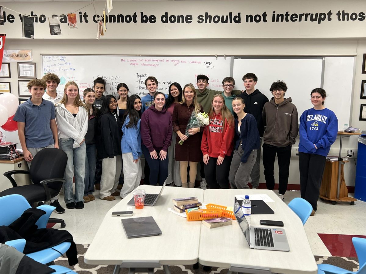 This year's staff of the Crimson posing with Mrs. Hunkele following the announcement of her award