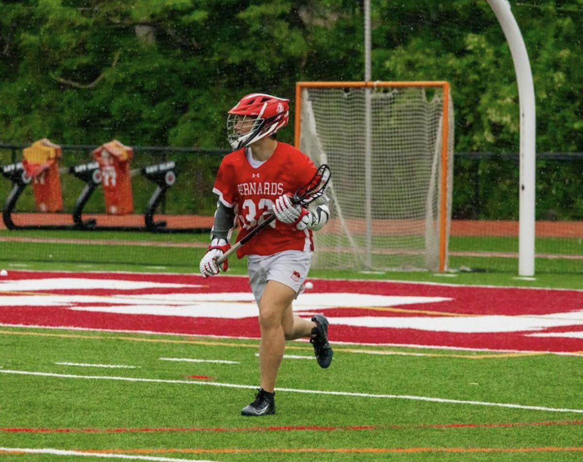 Logan Stevens '26 carries the ball in an attempt to score